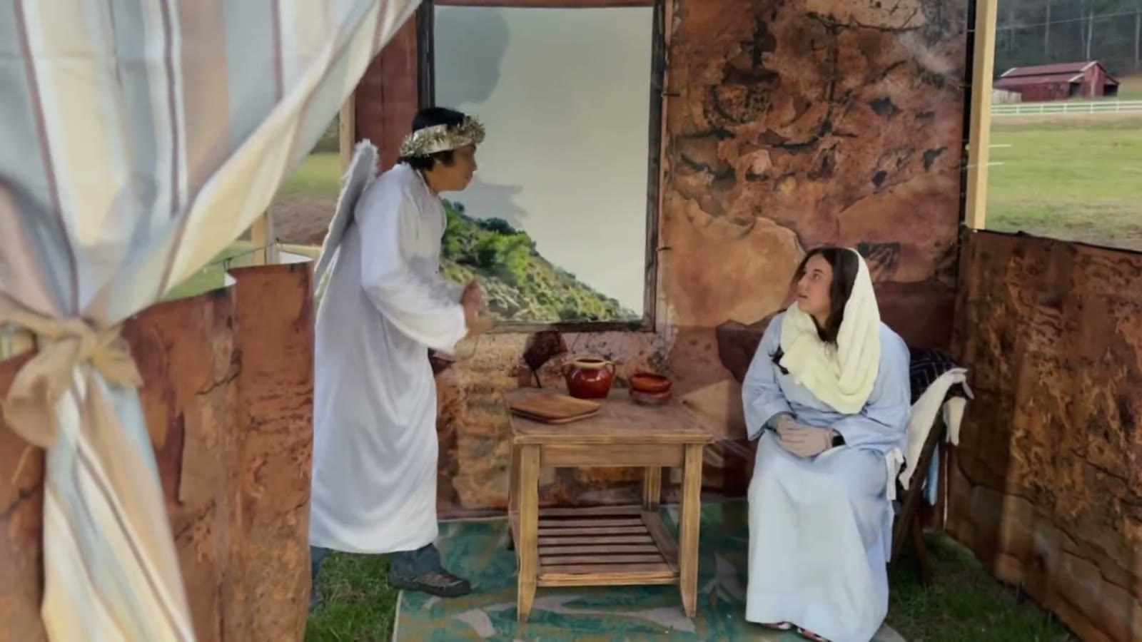 An angel in white appears to Mary in her home